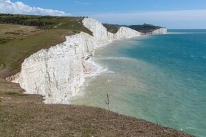  The Seven Sisters, a series of seven chalk cliff peaks along the East Sussex coast in England. Seaford head in the background is on the other side of the River Cuckmere and not part of the Seven Sisters. In the foreground, Birling Gap.